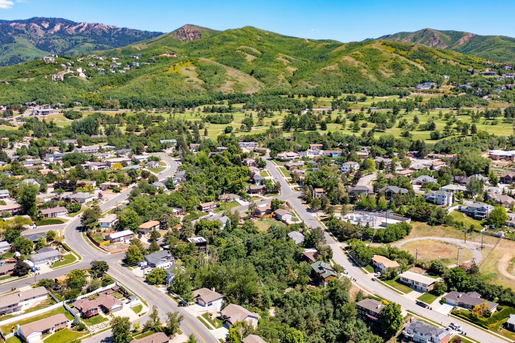 Aerial view of residential area featuring a mountainous background