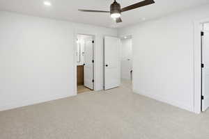 Unfurnished bedroom with ensuite bath, light colored carpet, a ceiling fan, and recessed lighting