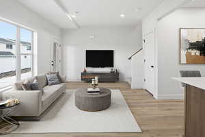Living room with light wood-style floors and recessed lighting