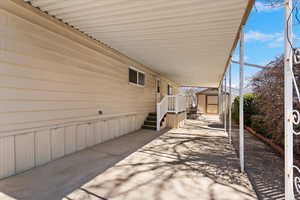 View of patio / terrace featuring a shed and an attached carport