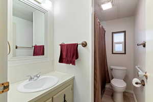 Bathroom with a shower with shower curtain and vanity