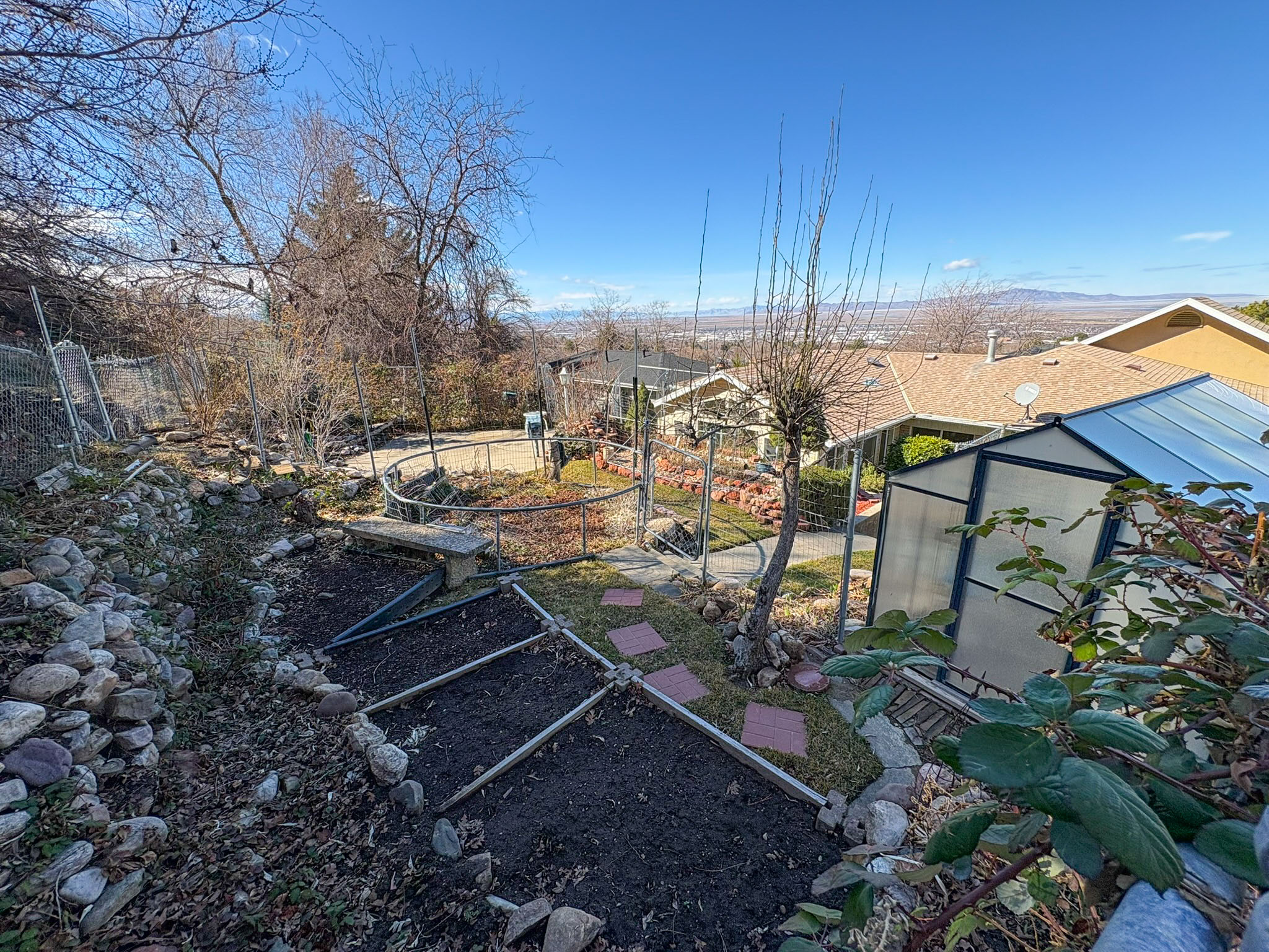 View of yard featuring an outbuilding, an exterior structure, and a garden
