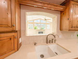 Kitchen view to the sunroom with a window over the fireplace