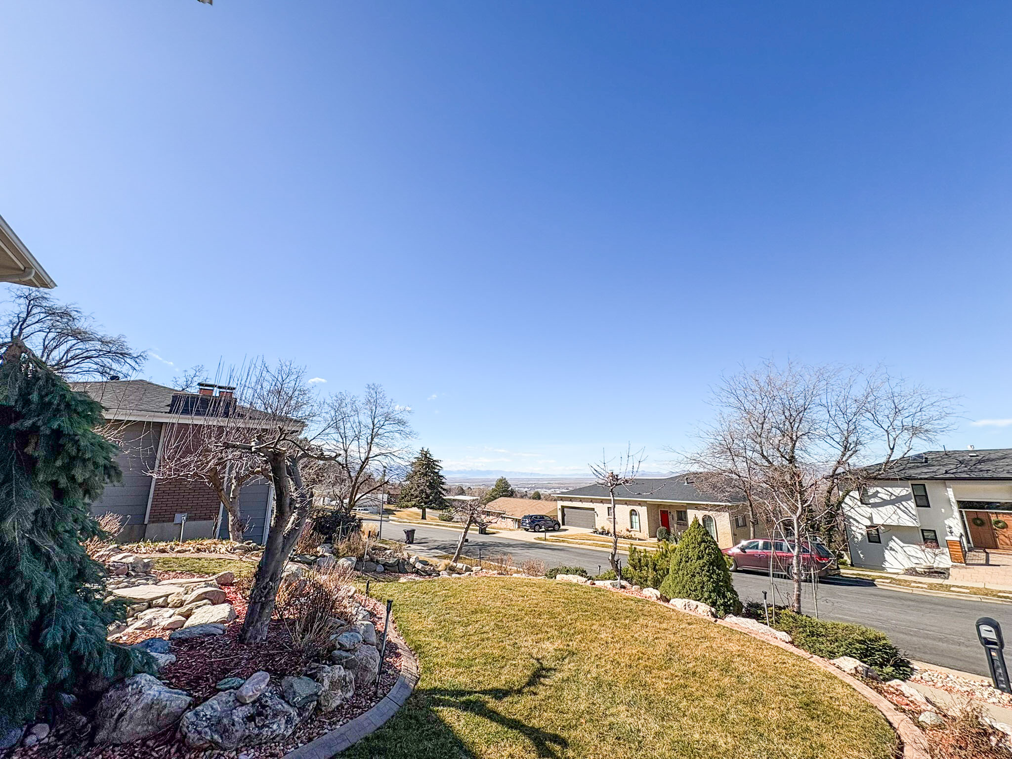 View of green lawn featuring a residential view