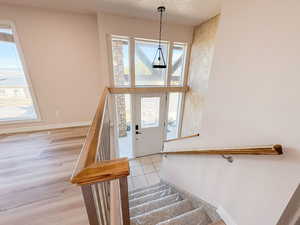Entrance foyer featuring stairway and light tile patterned floors