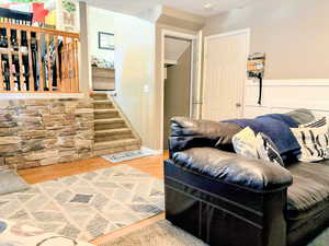 Living area with wood finished floors and stairs