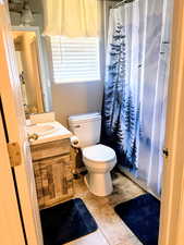 Full bath with vanity and a shower with curtain