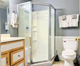 Bathroom with vanity, a shower stall, and light tile patterned floors