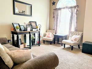Living area with carpet and baseboards