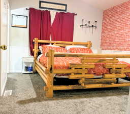 Carpeted bedroom with a wainscoted wall