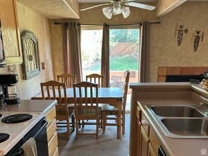 Dining room featuring a textured wall and a ceiling fan
