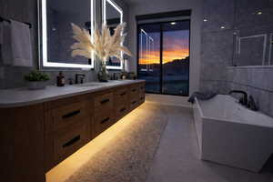 Full bath featuring double vanity and a freestanding tub