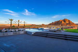View of patio featuring an outdoor pool and a mountain view