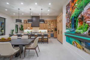 Dining area with recessed lighting and wine cooler