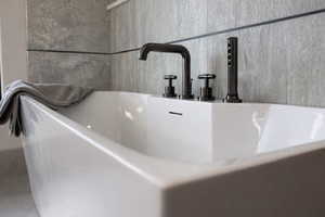 Bathroom view of a sink and a freestanding tub