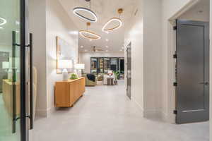 Hallway featuring recessed lighting and a high ceiling