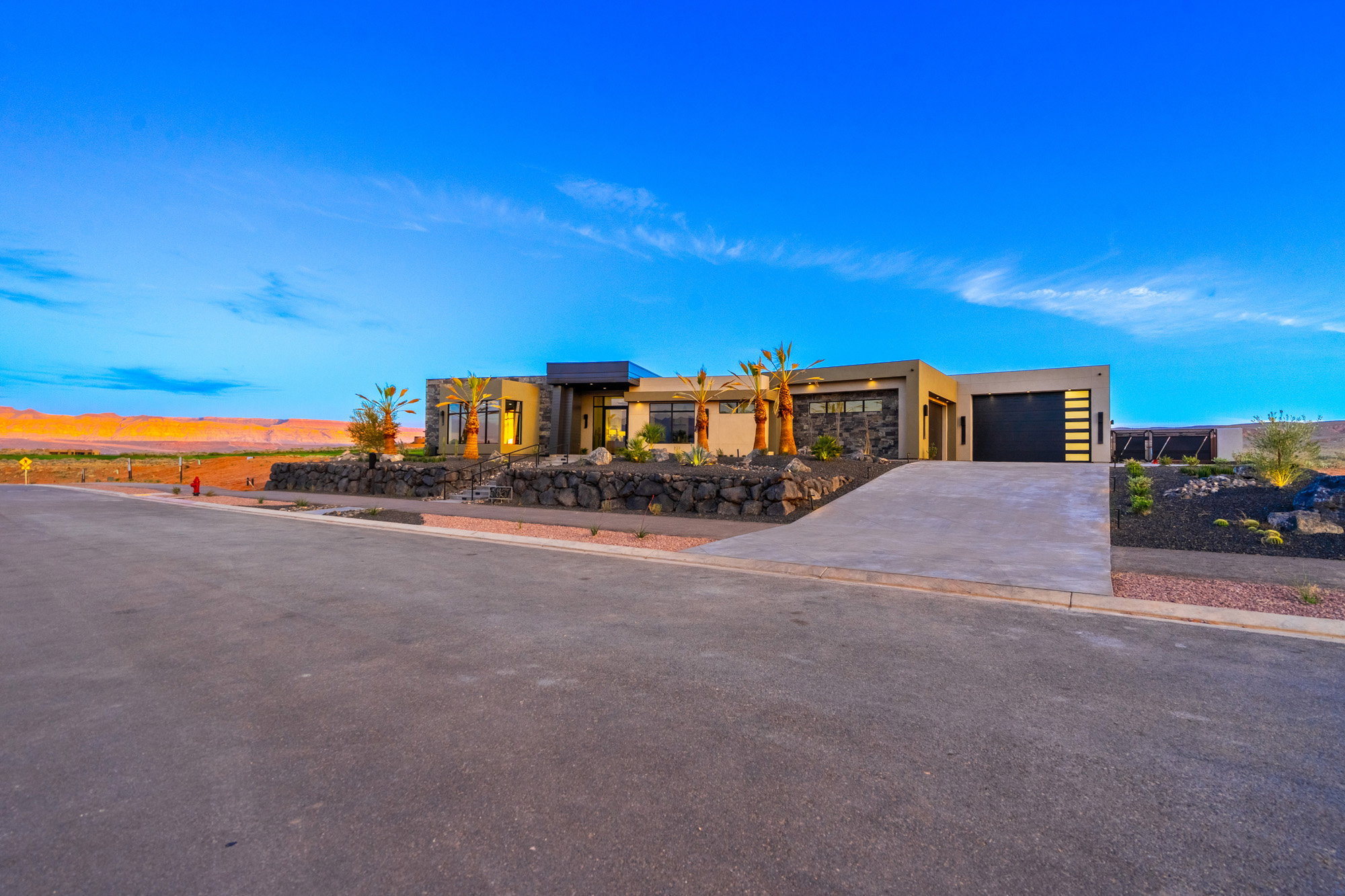 View of front of house with concrete driveway, stucco siding, and a garage