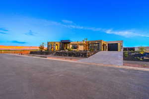 View of front of house with concrete driveway, stucco siding, and a garage