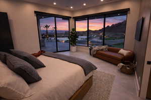 Bedroom featuring access to outside, recessed lighting, and a water and mountain view