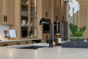 Kitchen view of light wood finish cabinets and light stone countertops