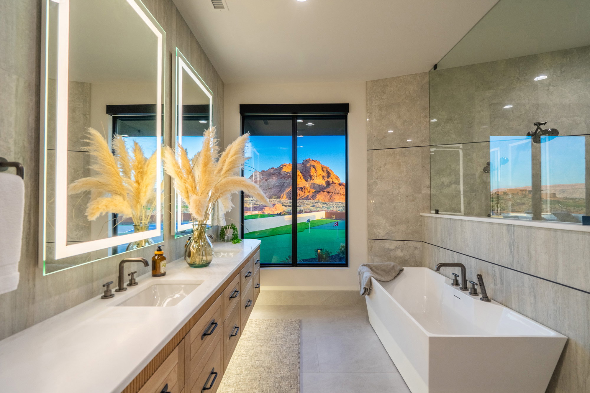 Full bath with vanity, a freestanding bath, and tile walls