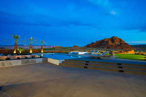 Swimming pool with a mountain view and a patio area