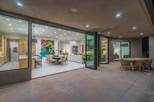 View of patio with outdoor dining space and a sink
