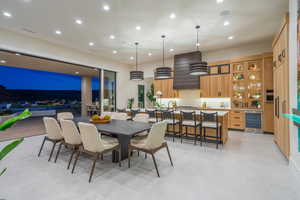 Dining area with wine cooler, recessed lighting, and finished concrete floors