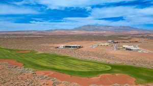 View of community with a mountain view, golf course view, and view of desert landscape