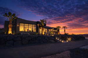 Rear view of property with stucco siding and a patio