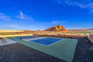 View of tennis court with a mountain view