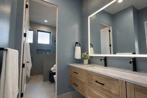 Bathroom with vanity, a stall shower, and recessed lighting