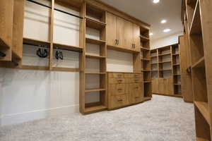 Walk in closet with light carpet