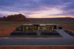 View of front of home with driveway, a mountain view, and a garage