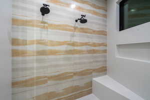 Full bath featuring a tile shower