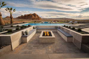 View of patio / terrace with an outdoor fire pit, a mountain view, and an outdoor pool