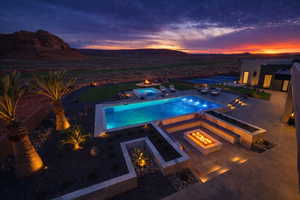 Outdoor pool featuring an in-ground hot tub, a patio area, a mountain view, and a fire pit