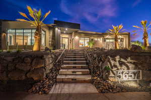 View of front of house featuring stairs and stucco siding