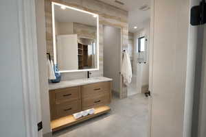 Bathroom featuring vanity and concrete floors