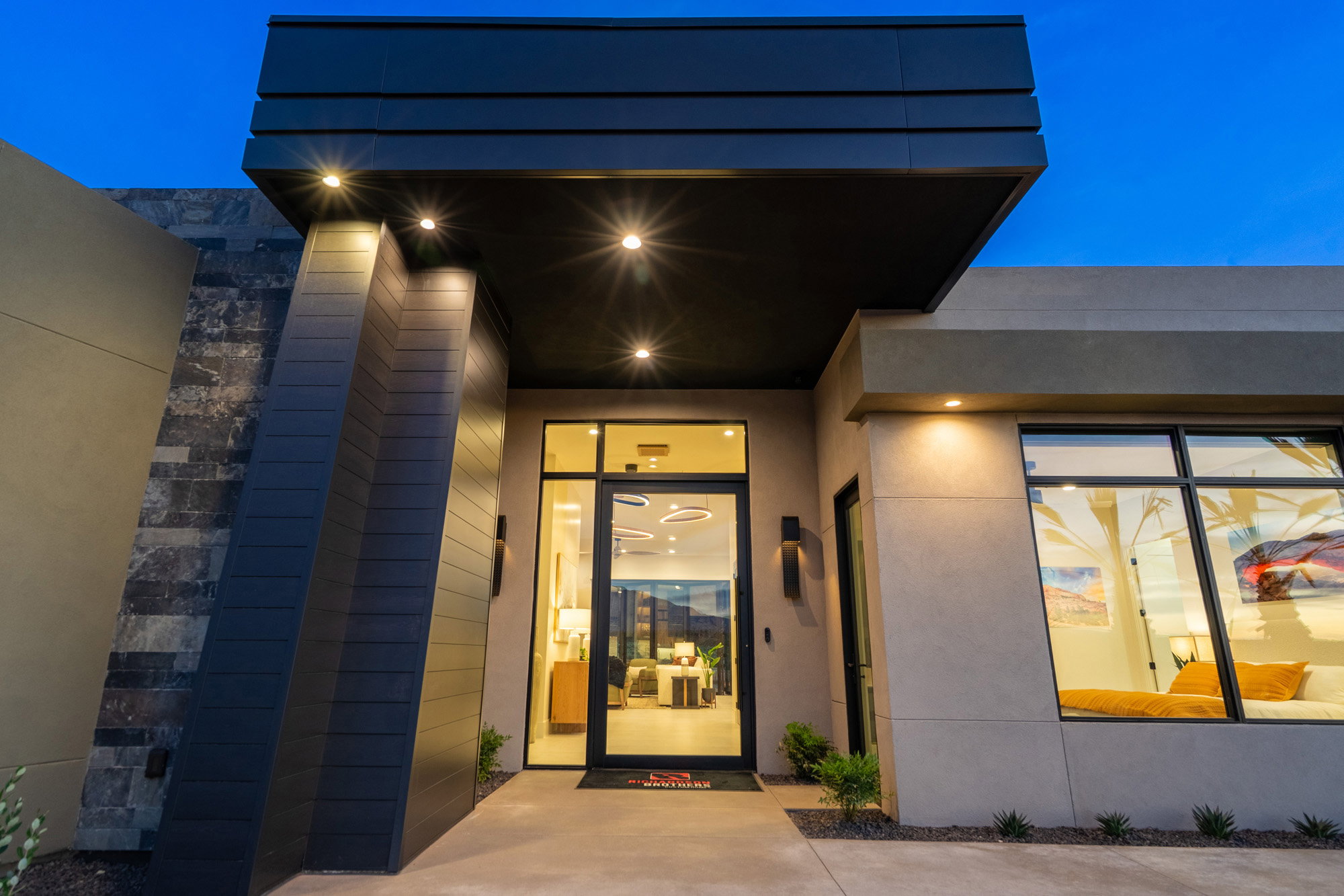 Exterior entry at twilight featuring stucco siding