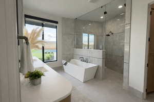 Full bath with walk in shower, a freestanding tub, plenty of natural light, and vanity