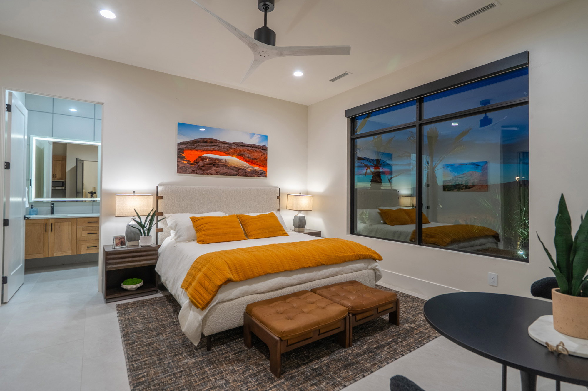 Bedroom featuring a ceiling fan and connected bathroom