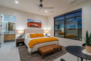 Bedroom featuring a ceiling fan and connected bathroom