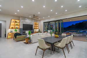 Dining room with recessed lighting, ceiling fan, and a fireplace