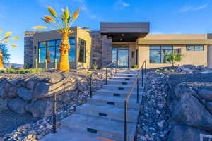 View of front of property with stucco siding and stone siding