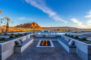 View of patio featuring an outdoor fire pit and a mountain view