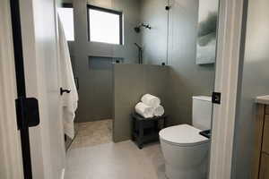 Full bathroom with vanity, walk in shower, and tile walls