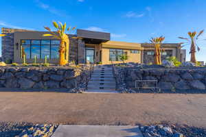 Modern home featuring stucco siding and stone siding