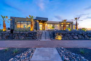 Contemporary home featuring stucco siding and stone siding