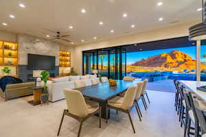 Dining room with recessed lighting, ceiling fan, and a fireplace
